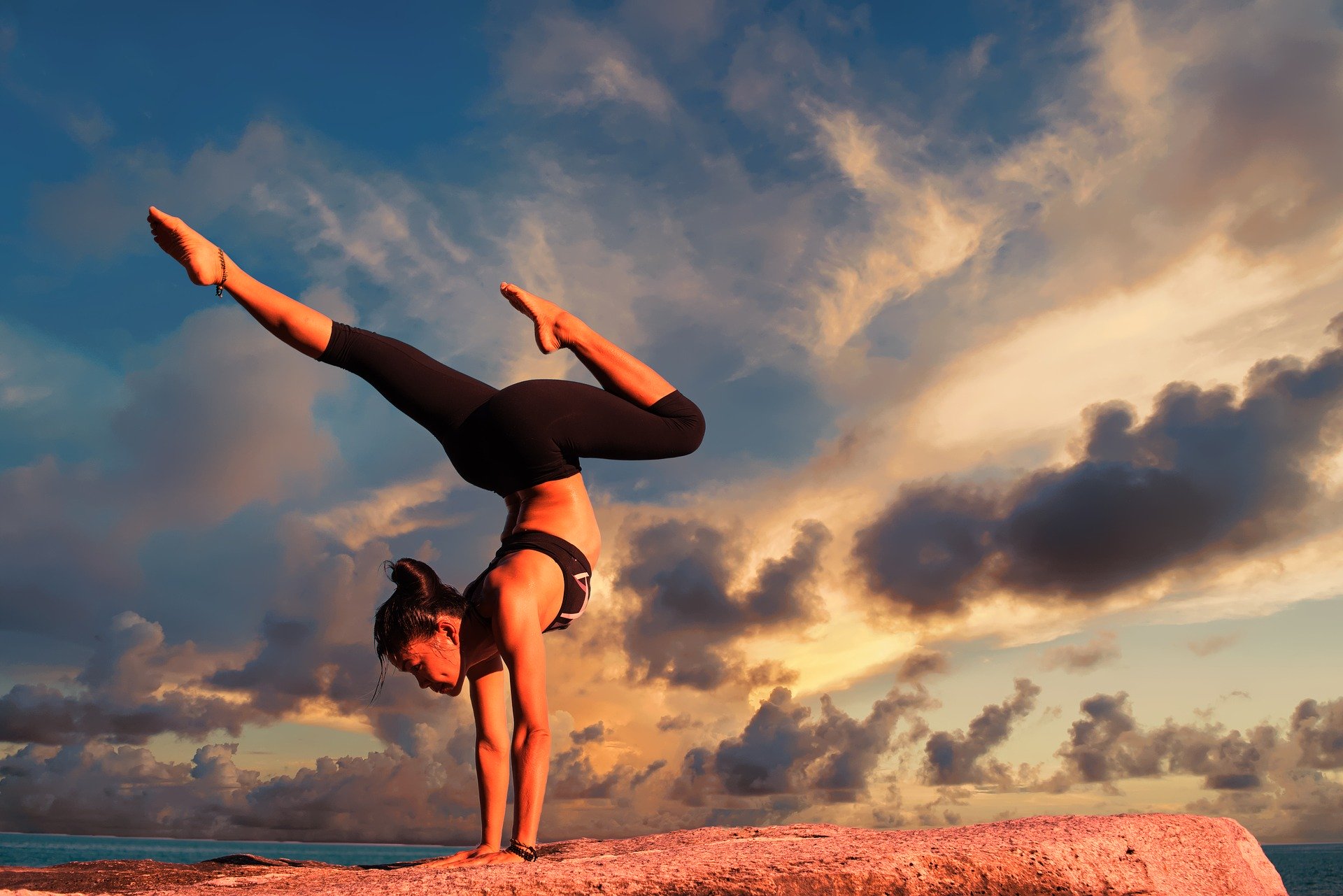 young female doing yoga pose outside