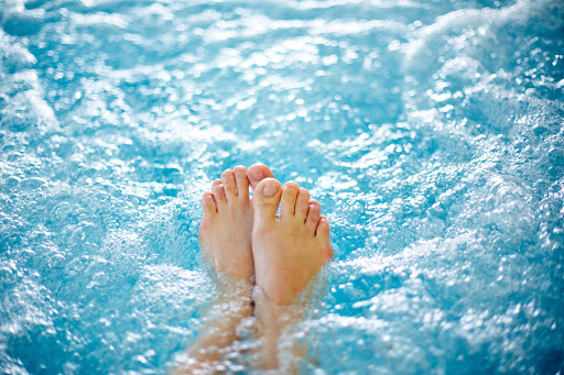 bare feet in hydrotherapy bath